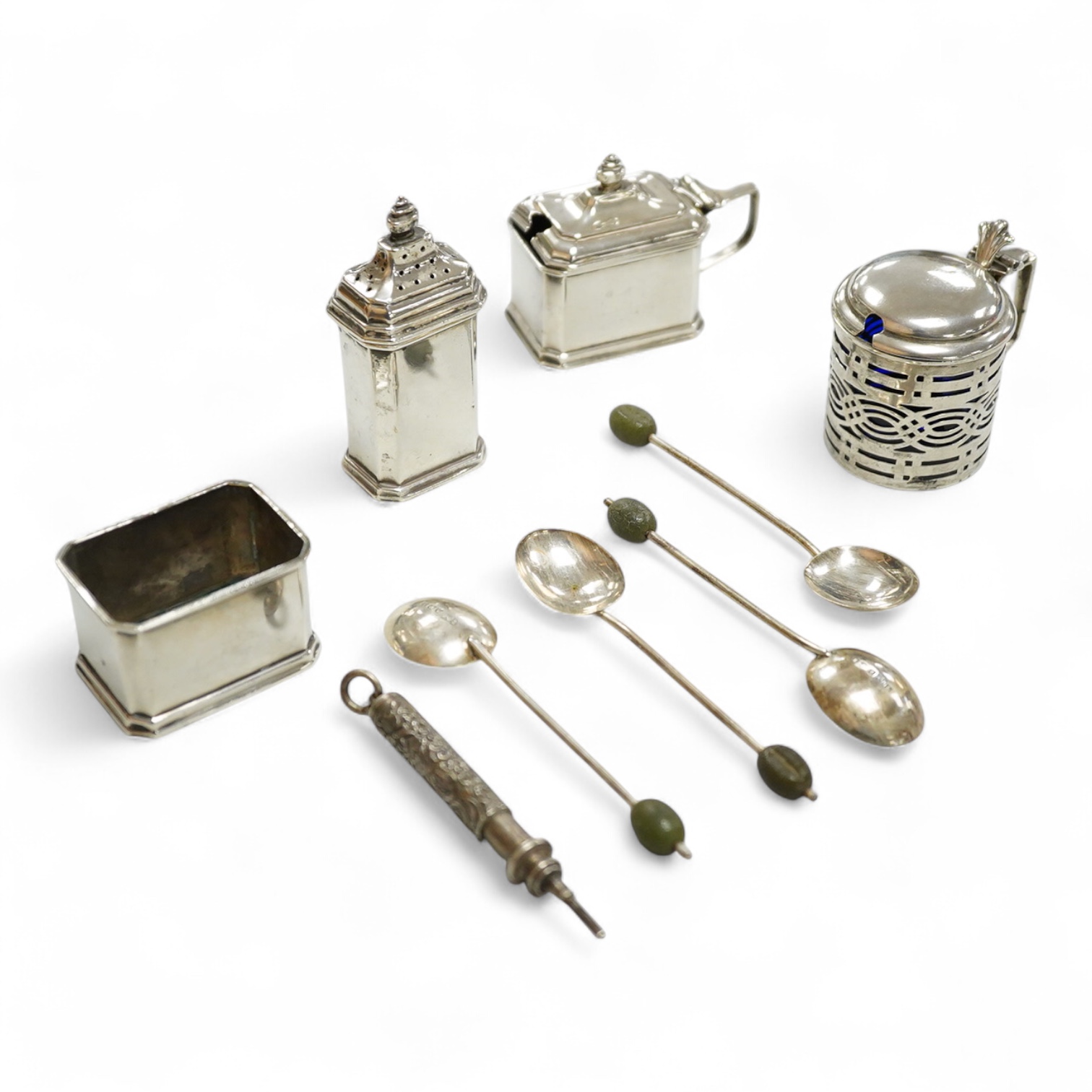 A George V silver three piece condiment set by Mappin & Webb, Birmingham, 1927(two lacking liners), together with one other silver mustard pot, four silver bean end coffee spoons and a white metal propelling pencil.